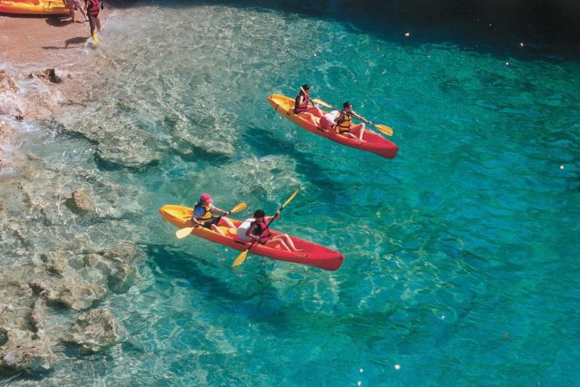 a family vacationing in Croatia having an outdoor adventure by kayaking