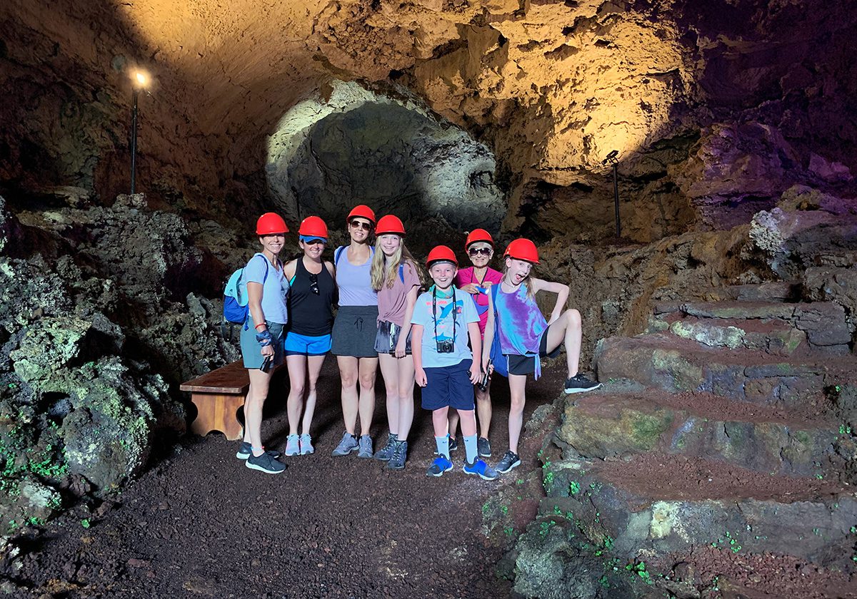 family in lava tunnel in galapagos islands